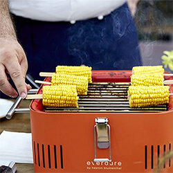 Small Image of Everdure Cube Portable Charcoal BBQ in Orange
