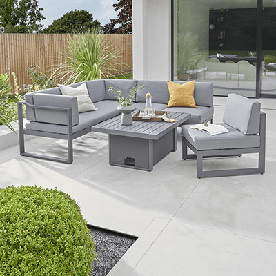 A metal Elba large low corner set. Set out on a patio in the perfect position to enjoy the rest of the garden. Dotted with other Kettler accessories to complement the luxurious set