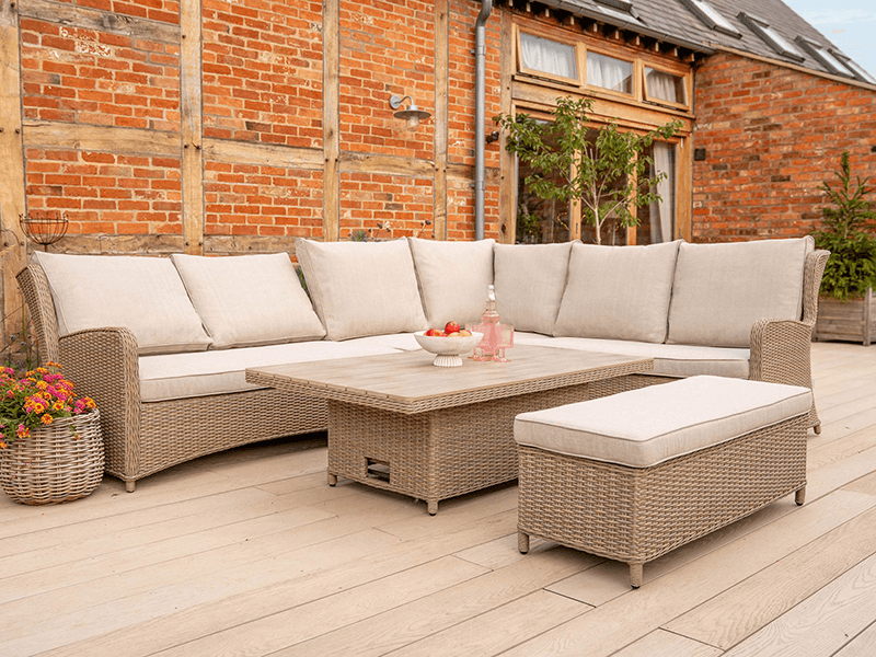 Kettler Derwent 7 Seat Rectangular Corner Sofa with a bench and an adjustable table on a paved patio
