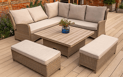 Image of the derwent rattan corner sofa displaying the reclining feature with adjustable table and benches