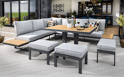 Image of Hartman Sonas Rectangular Platform garden furniture set with Side Tables, situated on a patio next to a house
