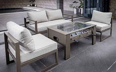 Hartman Toca Football Table and Lounge Seating. Positioned on a wooden patio with a garden backing