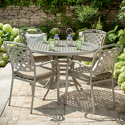 Image of Hartman Berkeley 4 Seat Round Dining Set with a Maize toned metal frame and wheatgrass coloured seat pads, in a garden setting