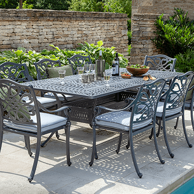 Image of Hartman Capri 8 Seat Dining Set with rectangular table and 8 seats with an antique grey metal frame and platinum coloured seat pads