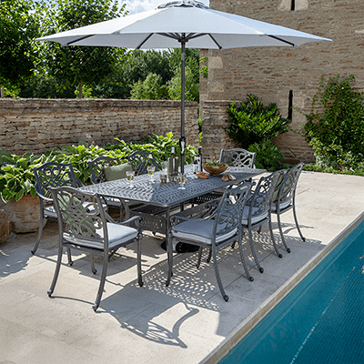 Image of Hartman Capri 8 Seat Dining Set with rectangular table and 8 seats with an antique grey metal frame and platinum coloured seat pads
