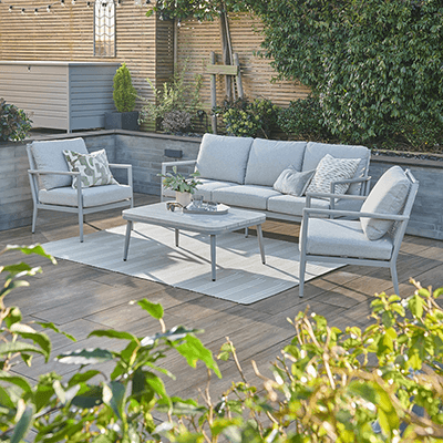 Studio image of Kettler Trento Lounge Set, with 2 weave backed metal chairs and sofa and a light toned coffee table