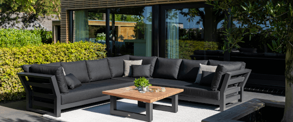 LIFE Nevada corner set with teak table-tops - set out infront of a garden room on a patio