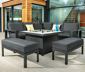 A fantastic firepit corner set with stools. With a Xerix frame, carbon cushion and a stylish modern design. The firepit is lit on a bright and windy day with a drink on the table too