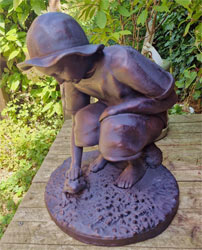 Image of Boy Playing with Frog Garden Ornament